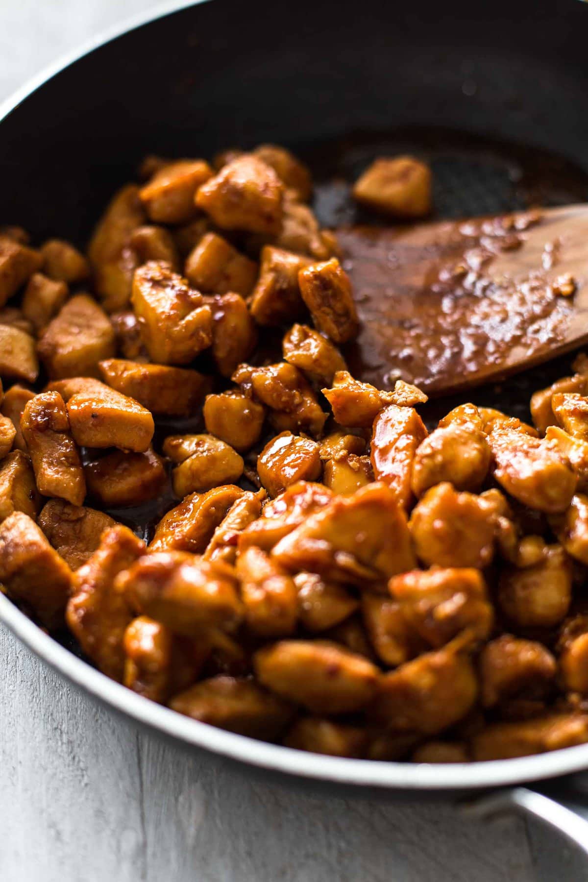 cooking bourbon chicken in a skillet