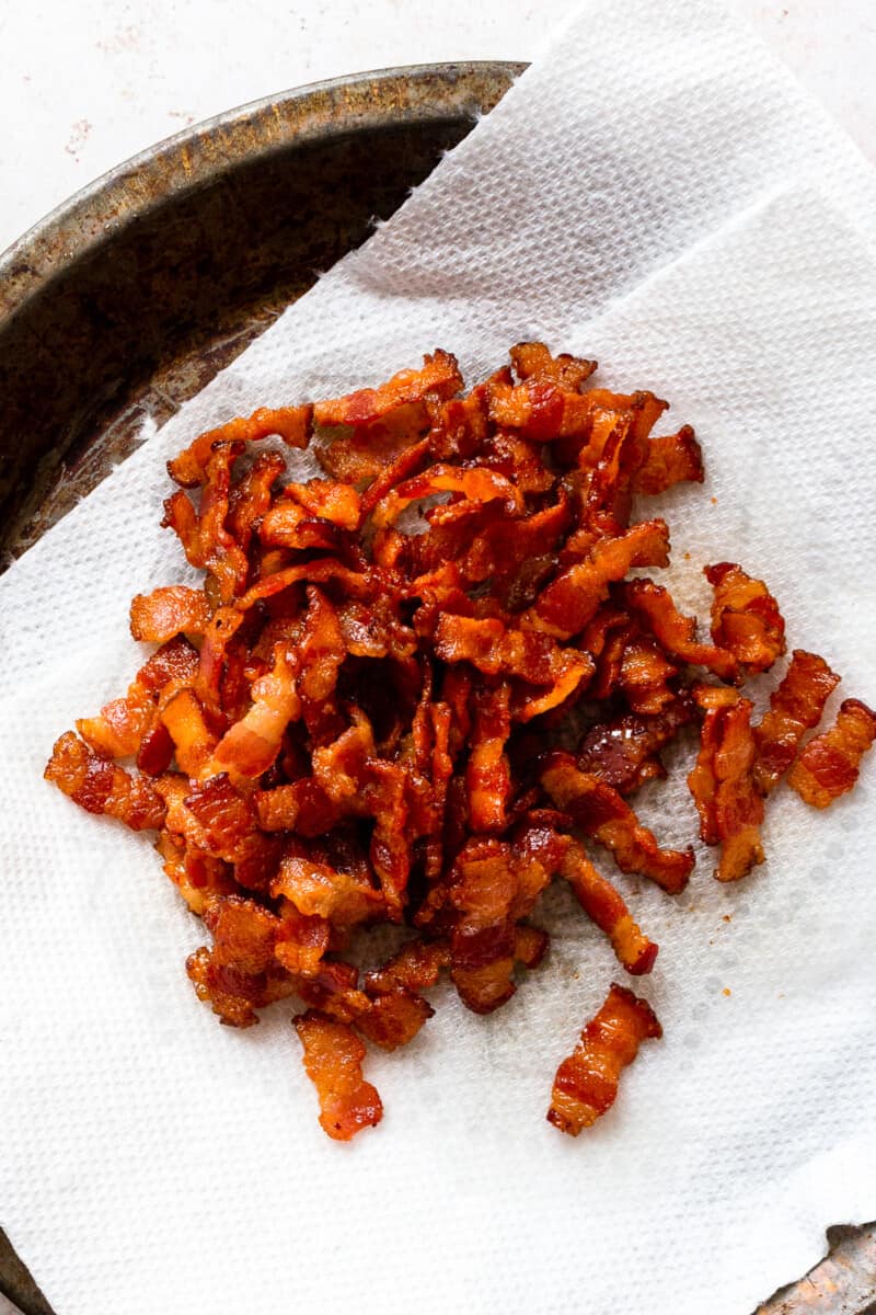 up close cooked bacon crumbles draining on paper towel