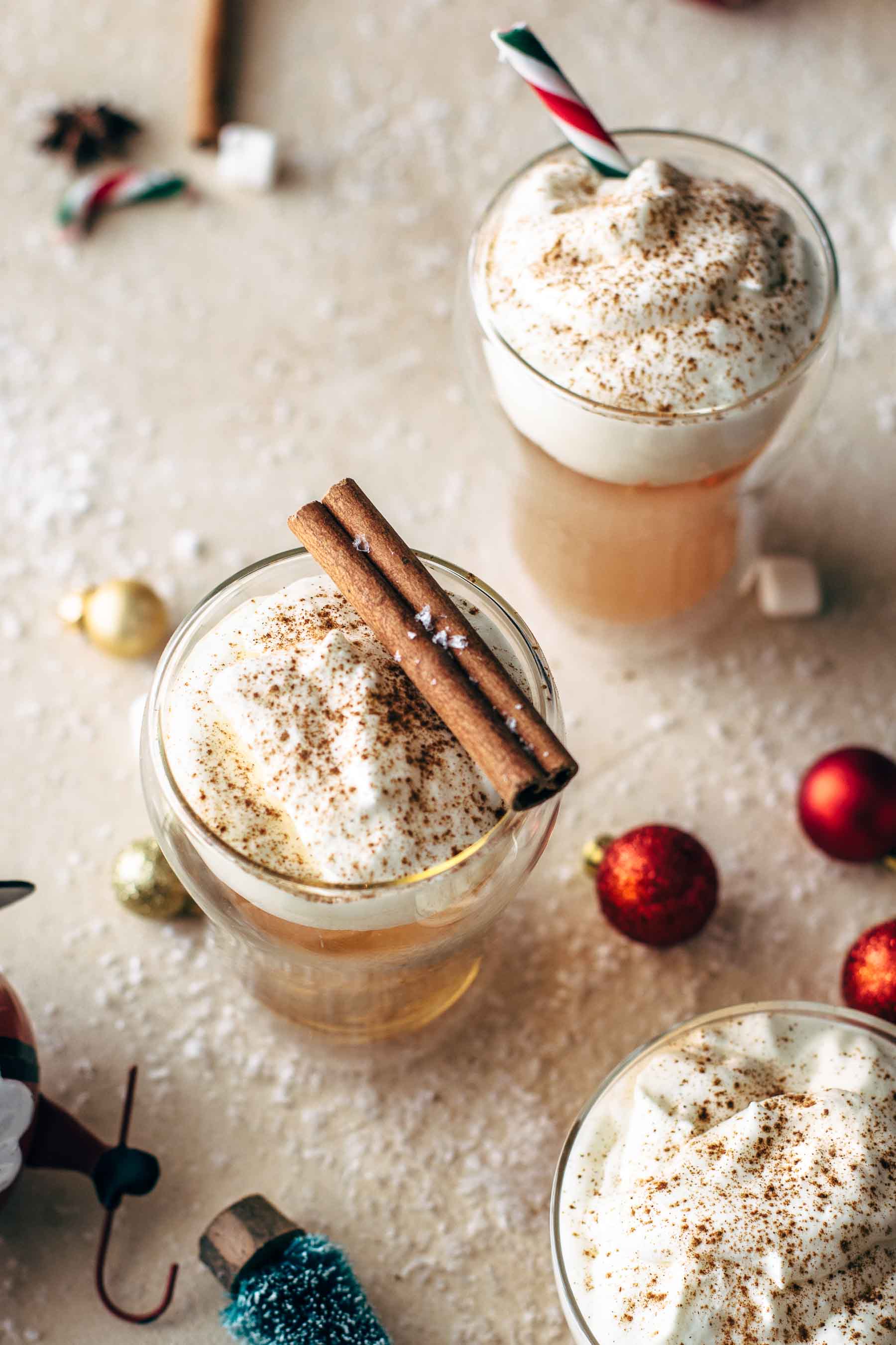 Caramel Apple Cider Hot Toddy in glasses, topped with whipped cream and cinnamon