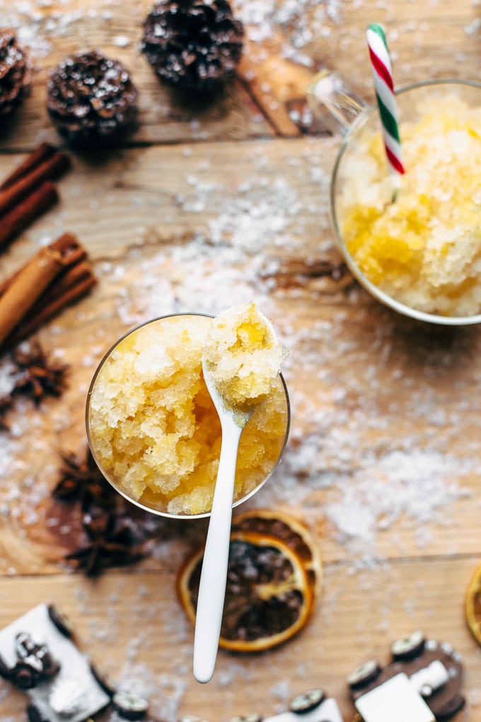 A glass and a small bowl filled with orange bourbon slush