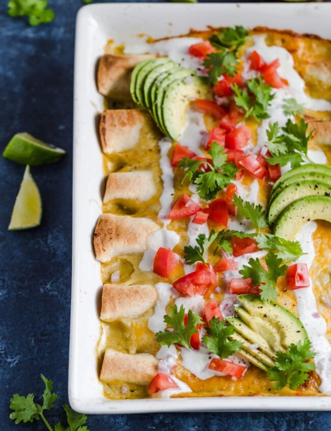 Honey Lime Chicken Enchiladas are a little bit sweet, a little bit spicy, and a whole lot of yummy! The chicken is marinated in a delicious honey lime mix, making the perfect base for these enchiladas. This easy chicken enchilada recipe is cheesy, flavorful, and fun. Try them out for your next dinner!