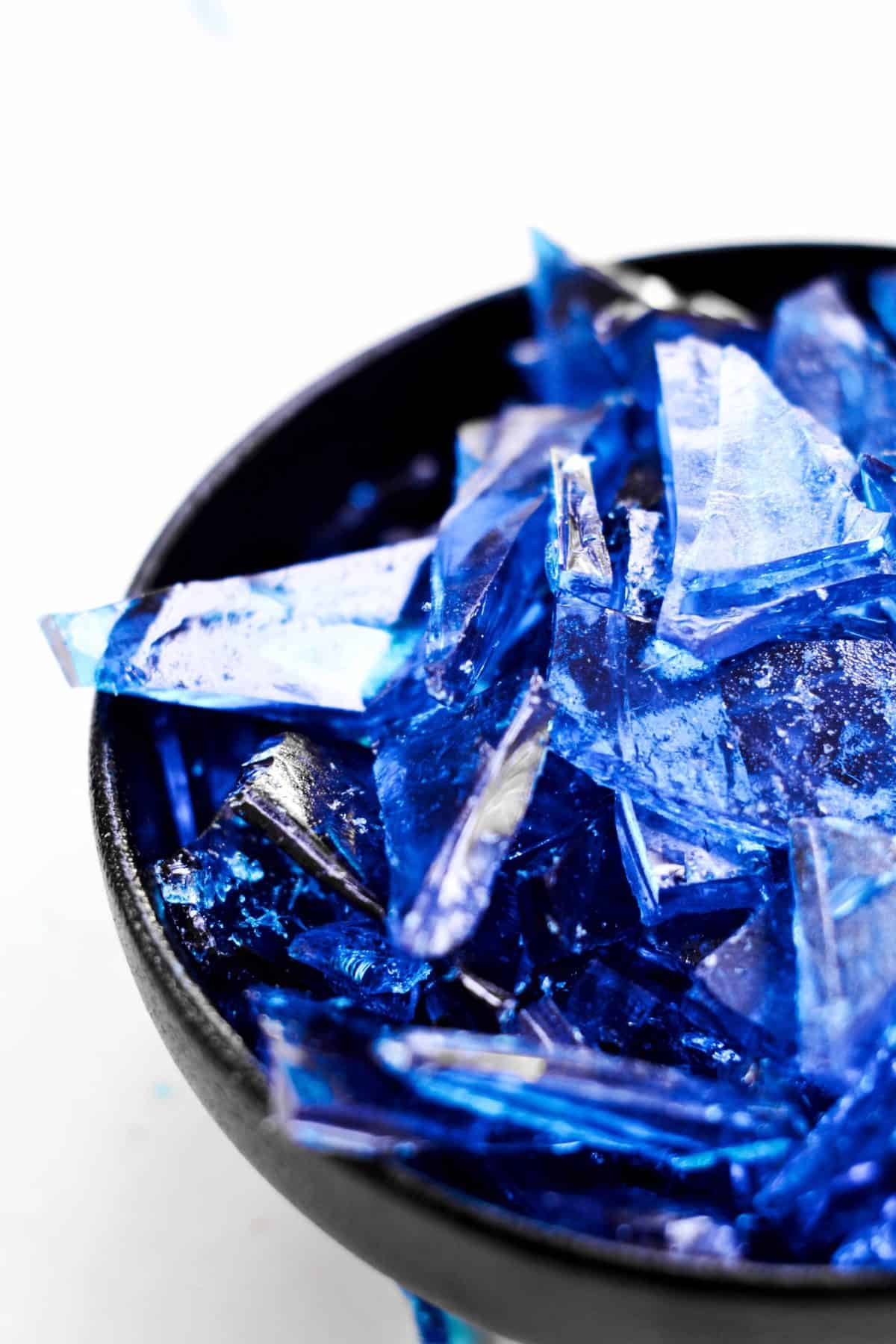 Shards of blue colored candy in a bowl.