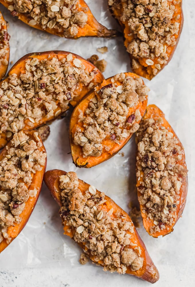 Twice baked sweet potatoes topped with a pecan, sugar, oatmeal, cinnamon mixture