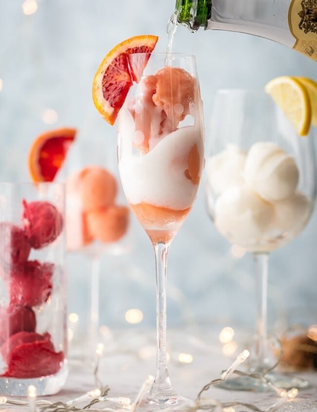 This is one of the BEST MIMOSA RECIPES for any brunch. It would even make a great dessert cocktail.  Sherbet Mimosas are a fun and creative way to dress up any mimosa recipe! Use the ice cream, sherbet, or sorbet flavor of your choice and mix with champagne. It's so fun, delicious, and beautiful! It's the perfect cocktail recipe to make for holidays, bridal showers, and beyond.