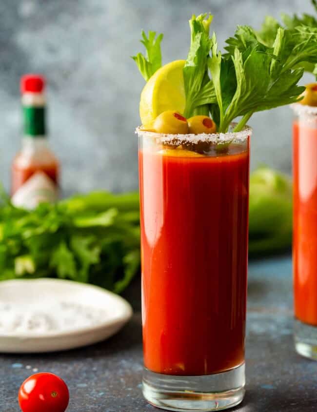 bloody mary in a tall glass with garnishes