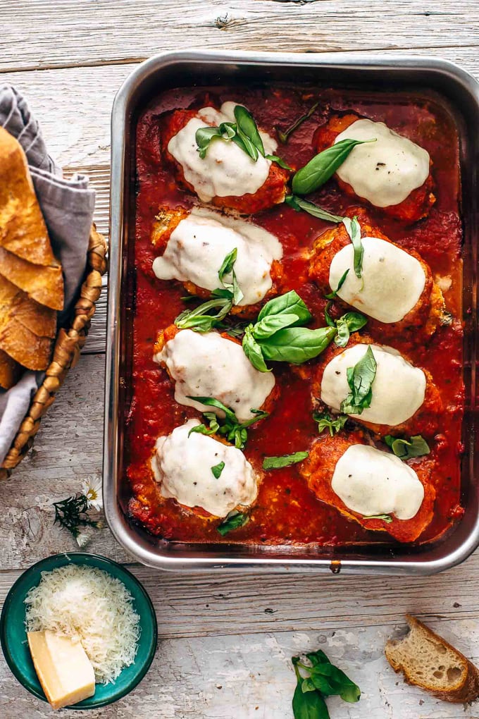 Baking pan filled with chicken roll ups, covered in marinara sauce