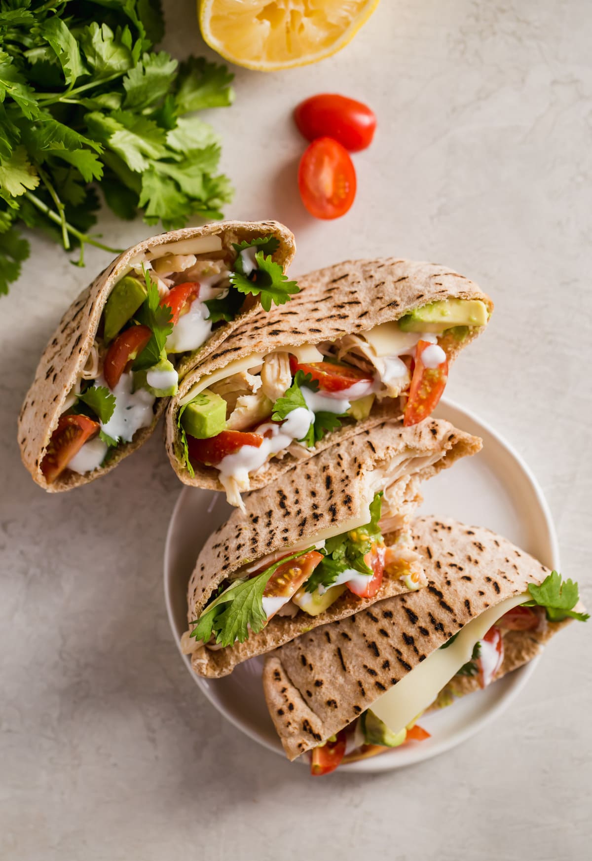 chicken avocado pita pocket sandwiches cut in half and laid out on a tabletop