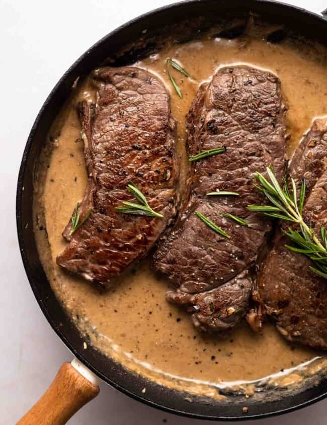 garlic rosemary steak in a skillet