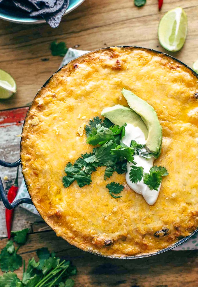 Chicken Enchilada Dip filled with cream cheese, shredded cheese, chicken, beans, corns, tomatoes, and more