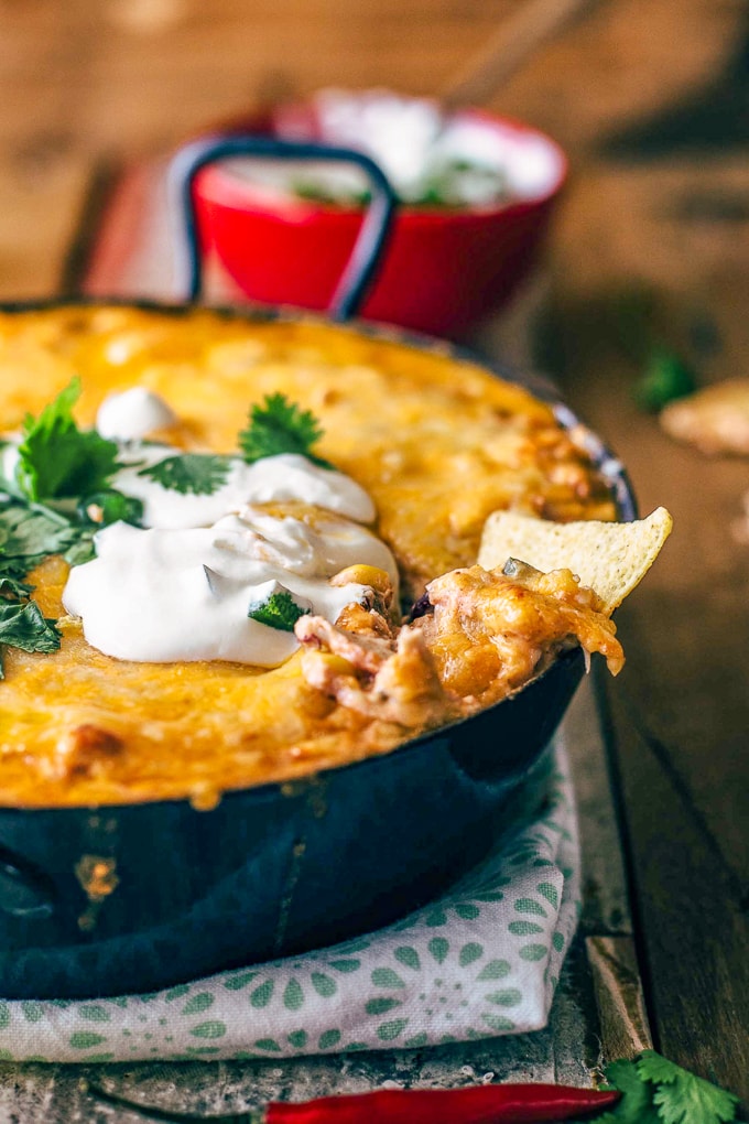 Tortilla chip dipped into chicken enchilada dip