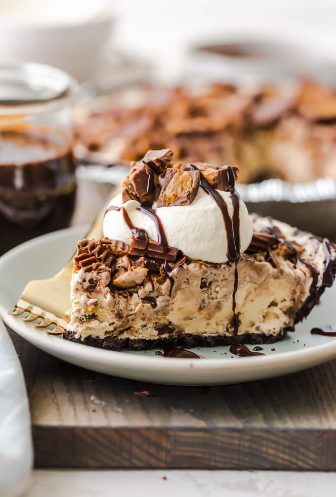 slice of pie on plate with whipped cream and chocolate drizzle