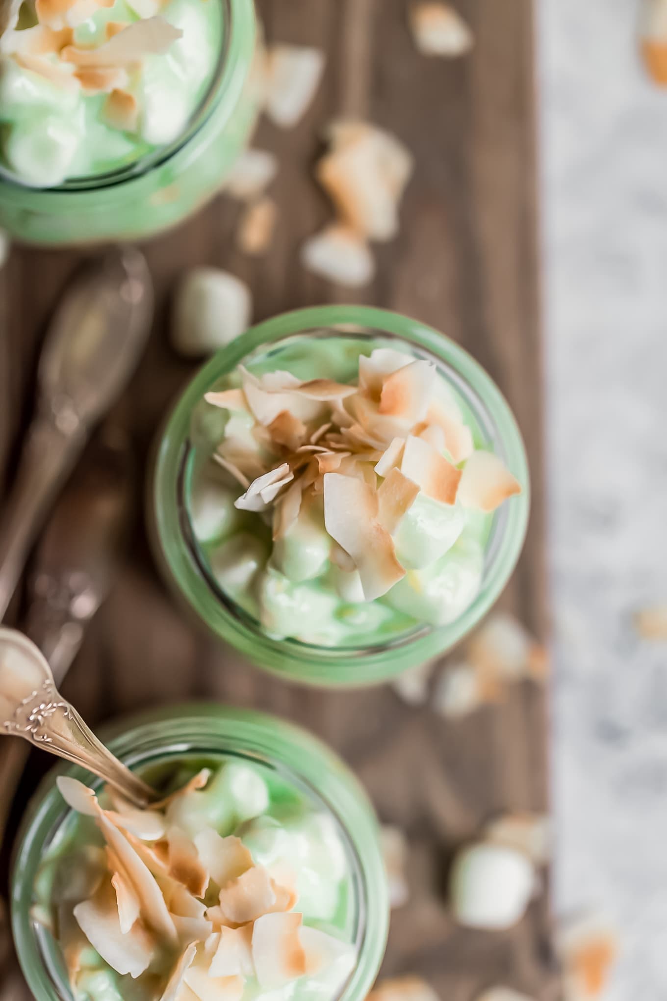 overhead view of pistachio fluff topped with marshmallows and coconut