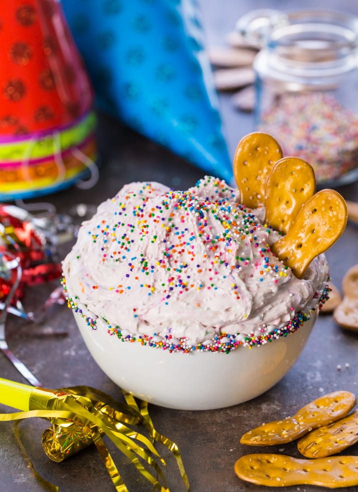 bowl of funfetti cake batter dip with pretzel chips in it