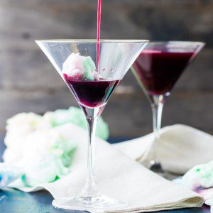 magic cotton candy martini being poured into glass