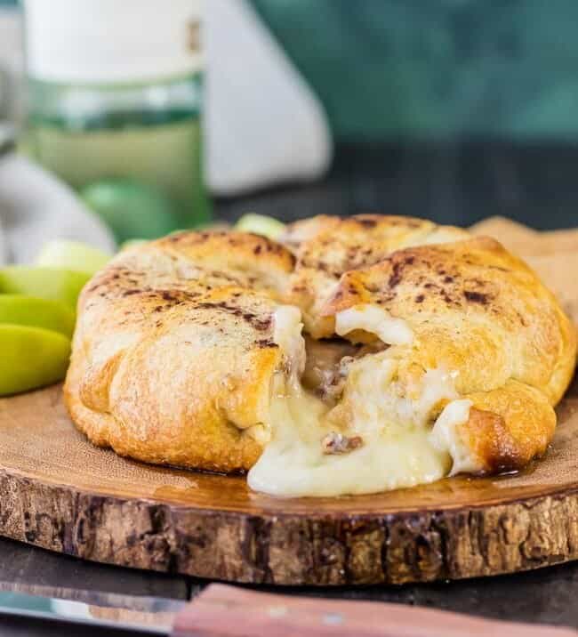 Apple Pie Baked Brie...a beautiful and delicious appetizer fit for any holiday party! We make this every Thanksgiving and Christmas and it's a party favorite every time!