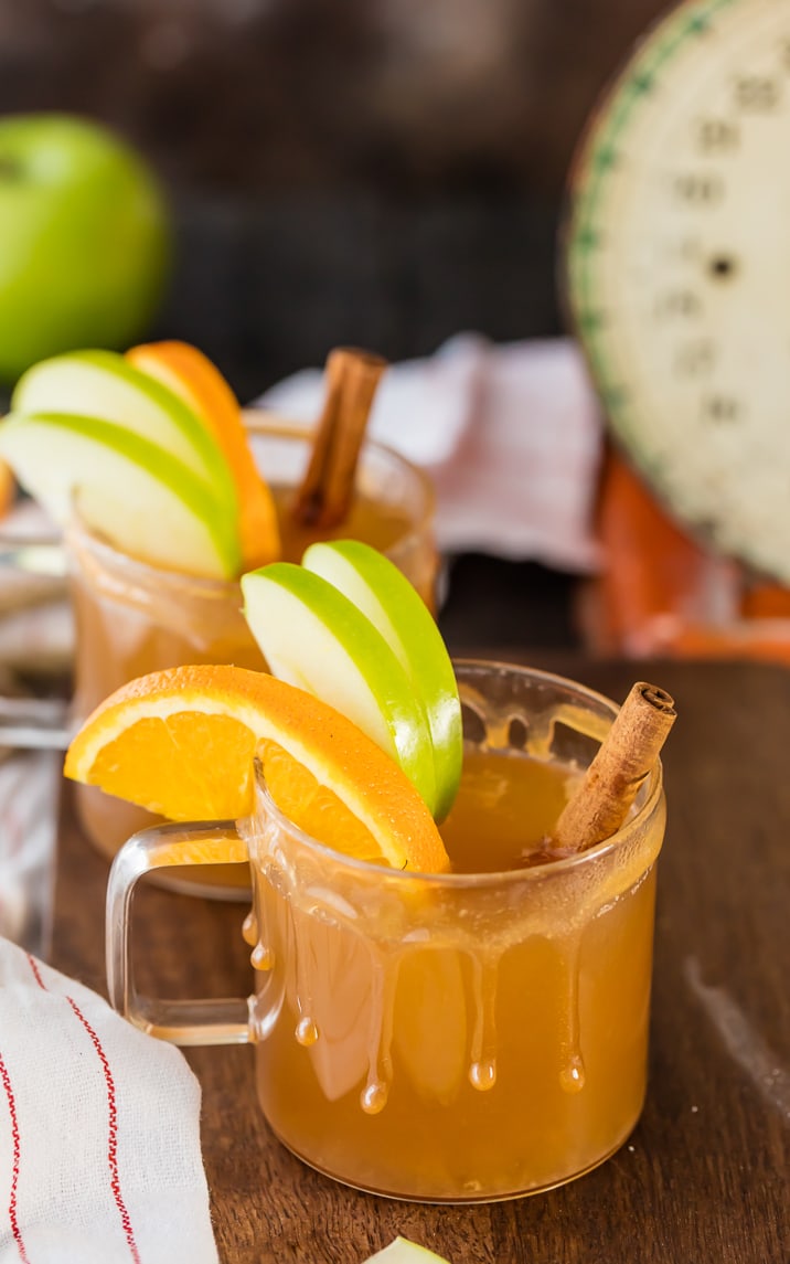 Caramel Apple Cider garnished with apple slices and cinnamon sticks