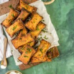 fried mini taco pizza pockets on a wooden plate