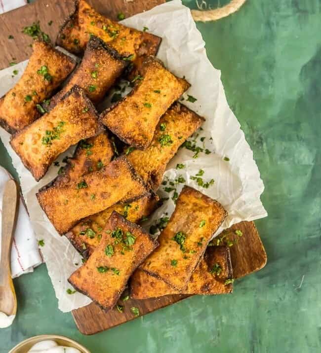 Mini Fried Taco Pizza Pockets...such a fun and simple appetizer or after school snack. ADDICTING! Fried Wontons stuffed with spicy beef, tomatoes, and cheese. These Taco Pizza Rolls are a favorite easy recipe!