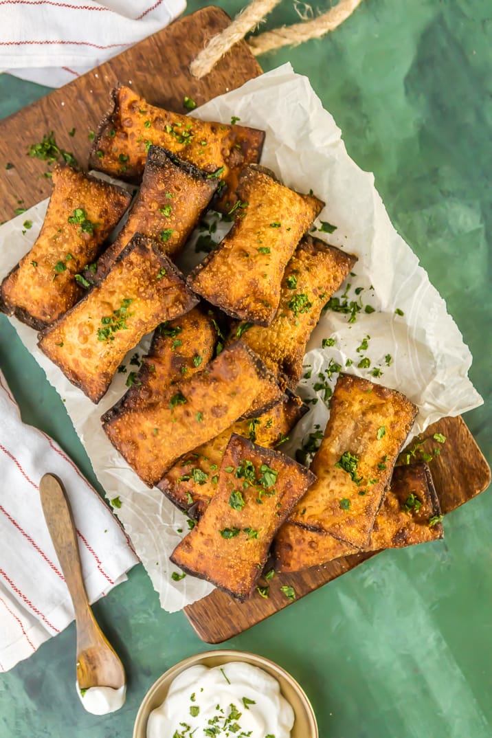 plate of mini fried taco pizza pockets on wooden board