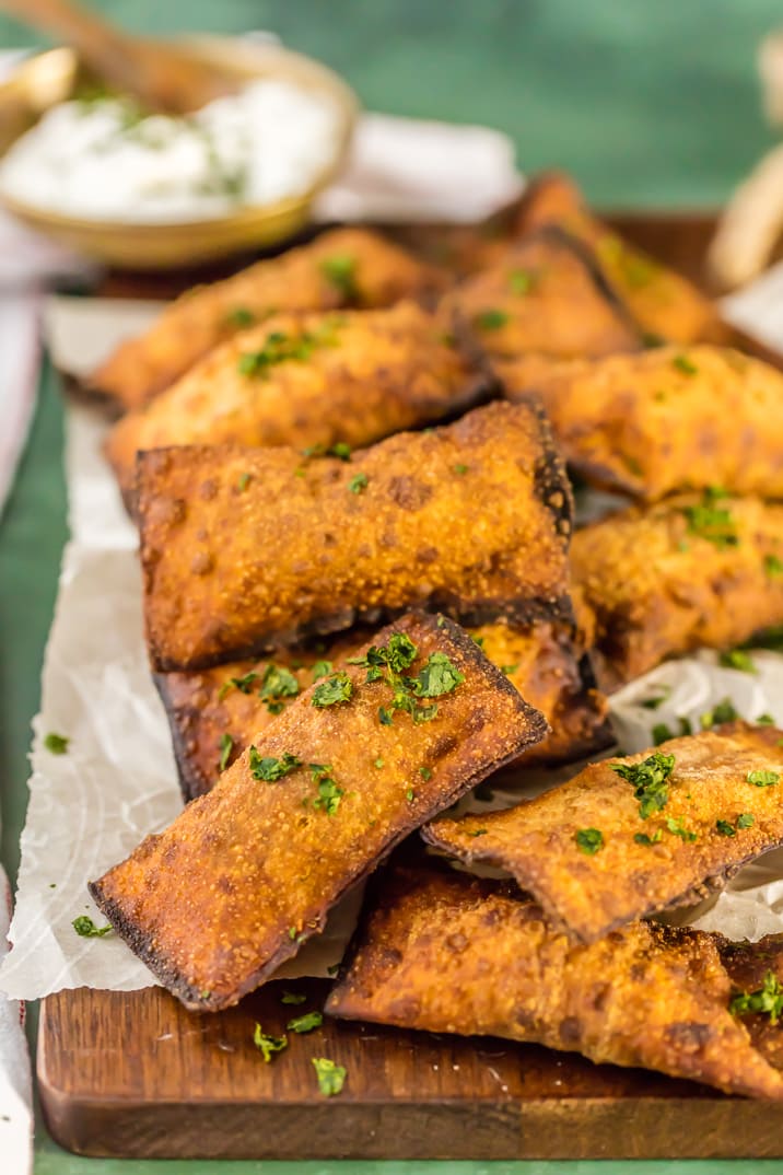 mini fried taco pizza pockets on wooden board