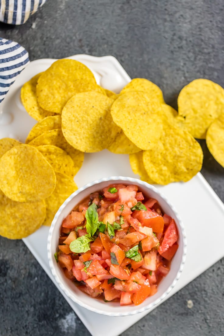 Italian salsa with tortilla chips on white plate