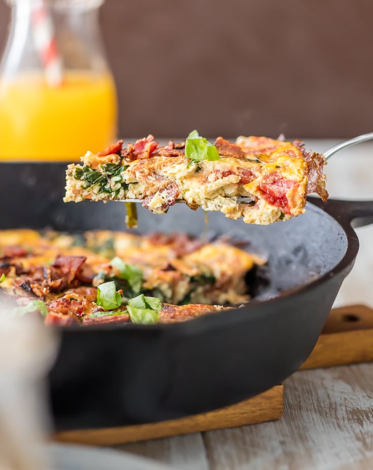 slice of one pan BLT skillet frittata out of a cast iron pan