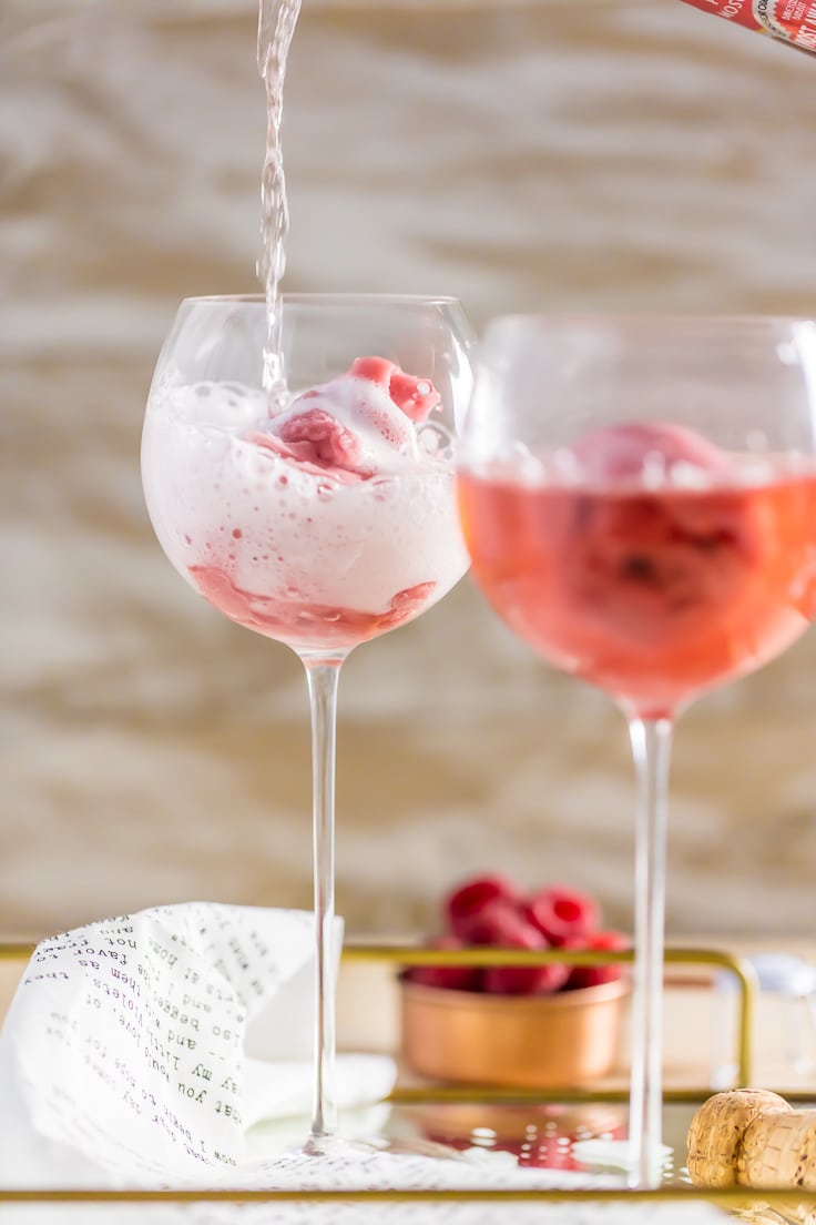 two pink champagne floats in wine glasses