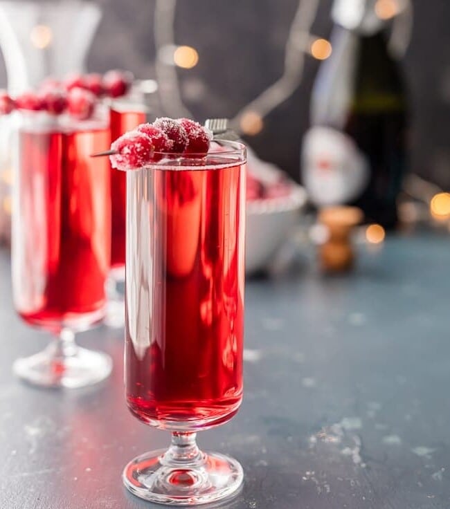 Sugared Cranberry Ginger Mimosas, ONLY THREE INGREDIENTS! Easy holiday cocktail recipe perfect for Thanksgiving, Christmas, and Valentine's Day! Pretty Red Cocktail!