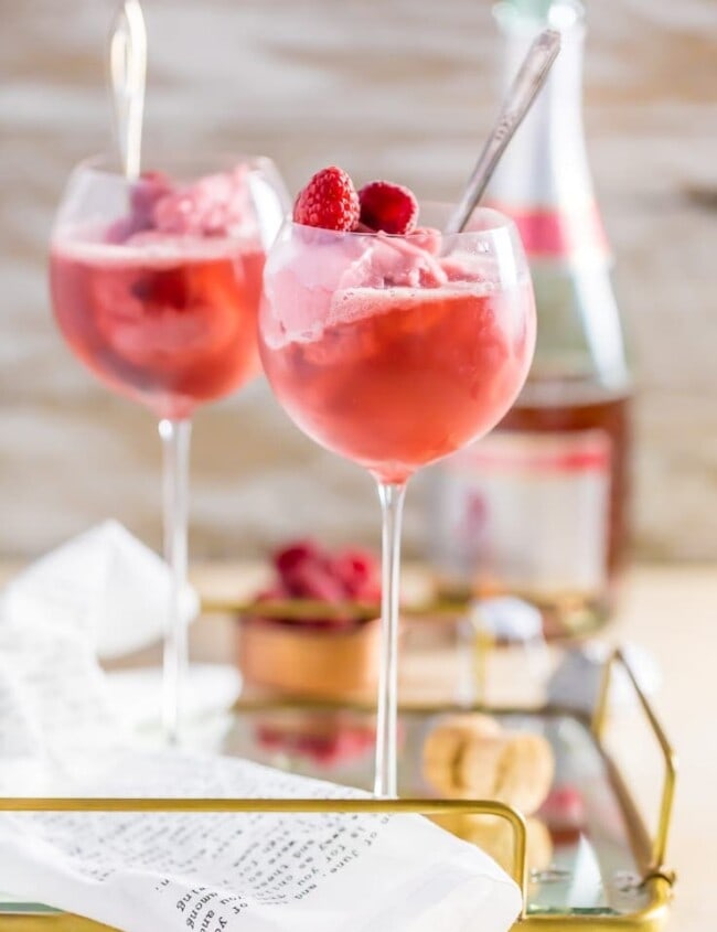 pink champagne floats in wine glasses on a tray