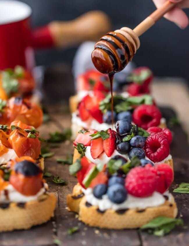 balsamic reduction being drizzled onto brushetta