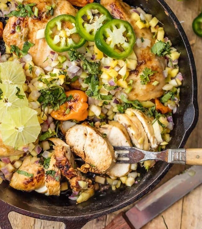 Make this SKINNY ONE PAN CARIBBEAN JERK CHICKEN SKILLET in just 15 minutes! Topped with mango salsa for a cool kick. A delicious and easy weeknight meal!