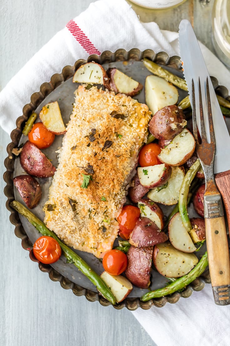 a plate of honey mustard crusted salmon, potatoes, tomatoes, and green beans