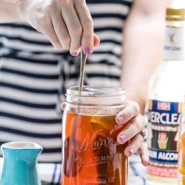 homemade peach teak vodka being stirred