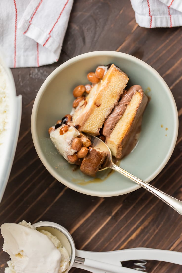 a slice of ice cream cake made with pound cake, vanilla and chocolate ice cream, caramel, and peanuts