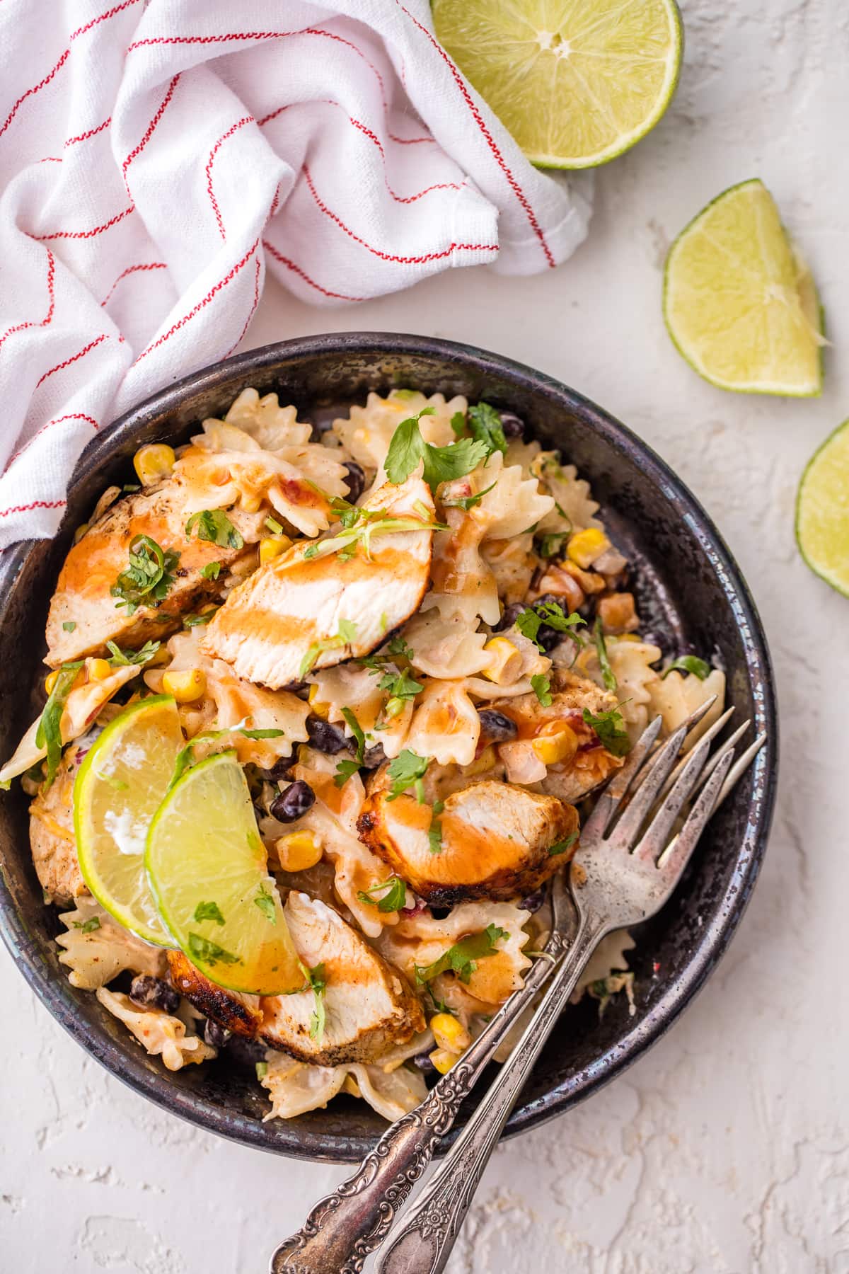 a bowl of pasta salad with corn, black beans, chicken, and more