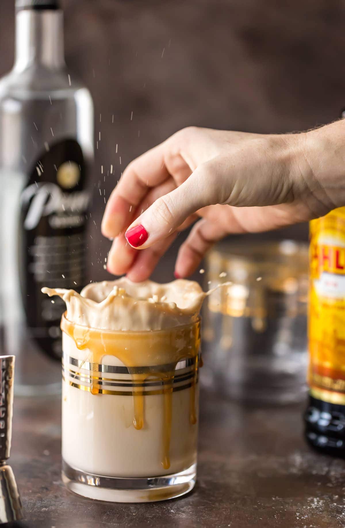 splashing an ice cube into a cocktail