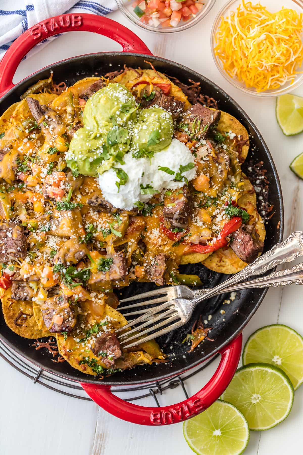 Steak Fajita Nachos in a skillet with two forks