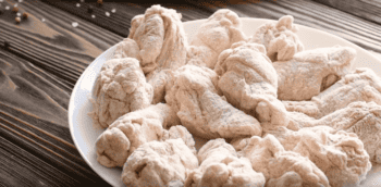 Gluten-free buffalo wings on a wooden table.