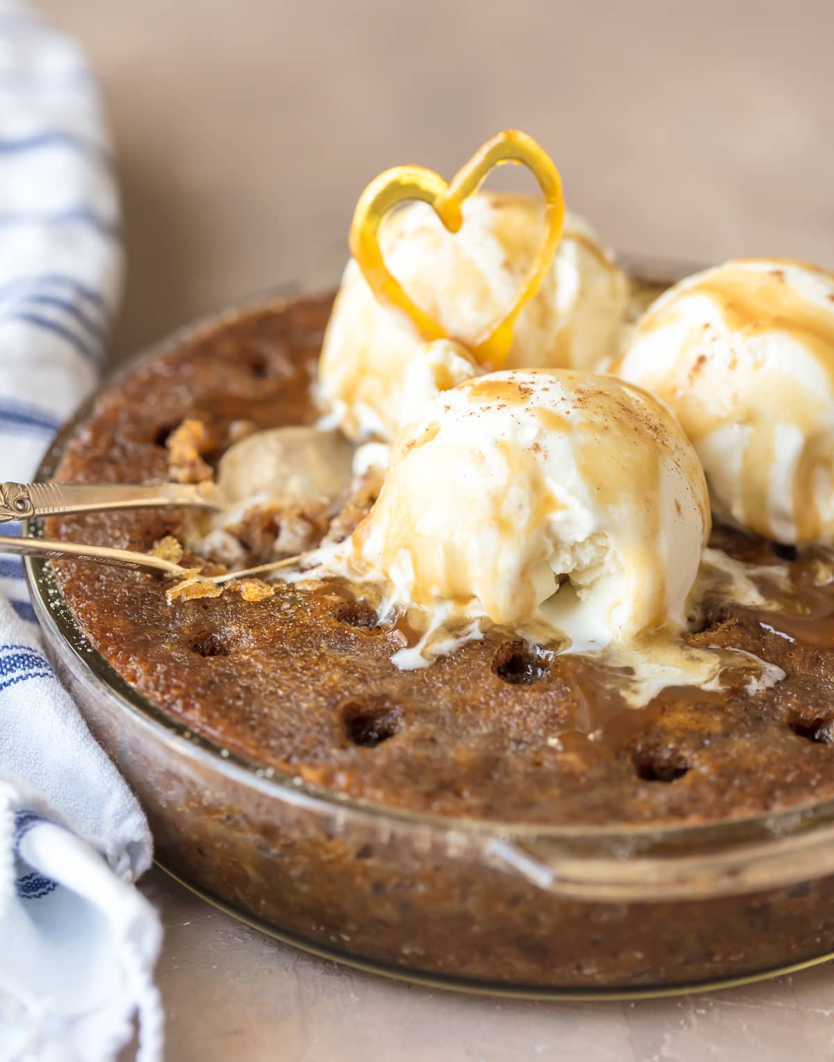 Sticky Toffee Pudding Cake topped with vanilla ice cream and toffee sauce