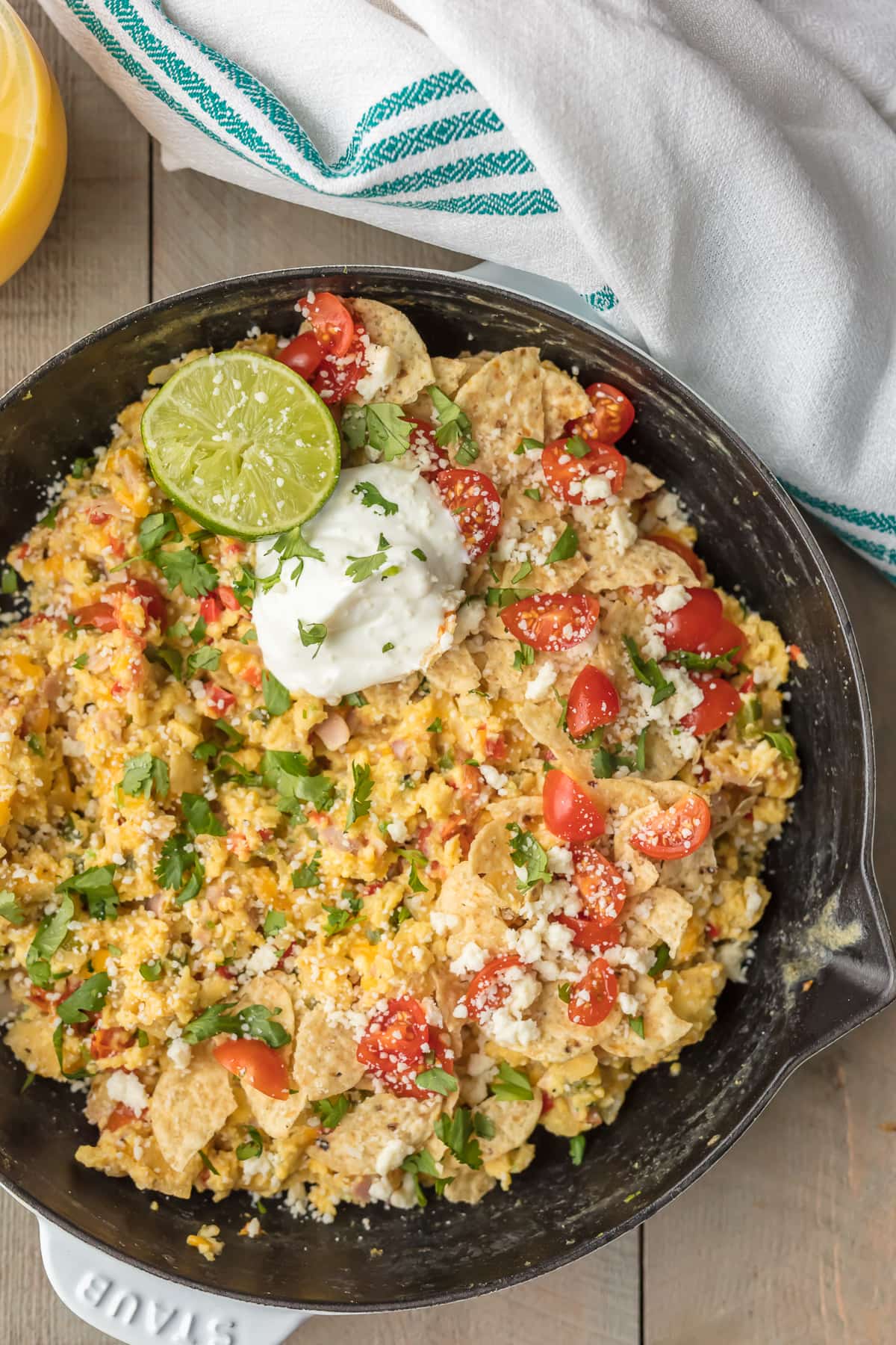 Cheesy Migas: eggs, tortilla chips, tomatoes, cheese, peppers, and more