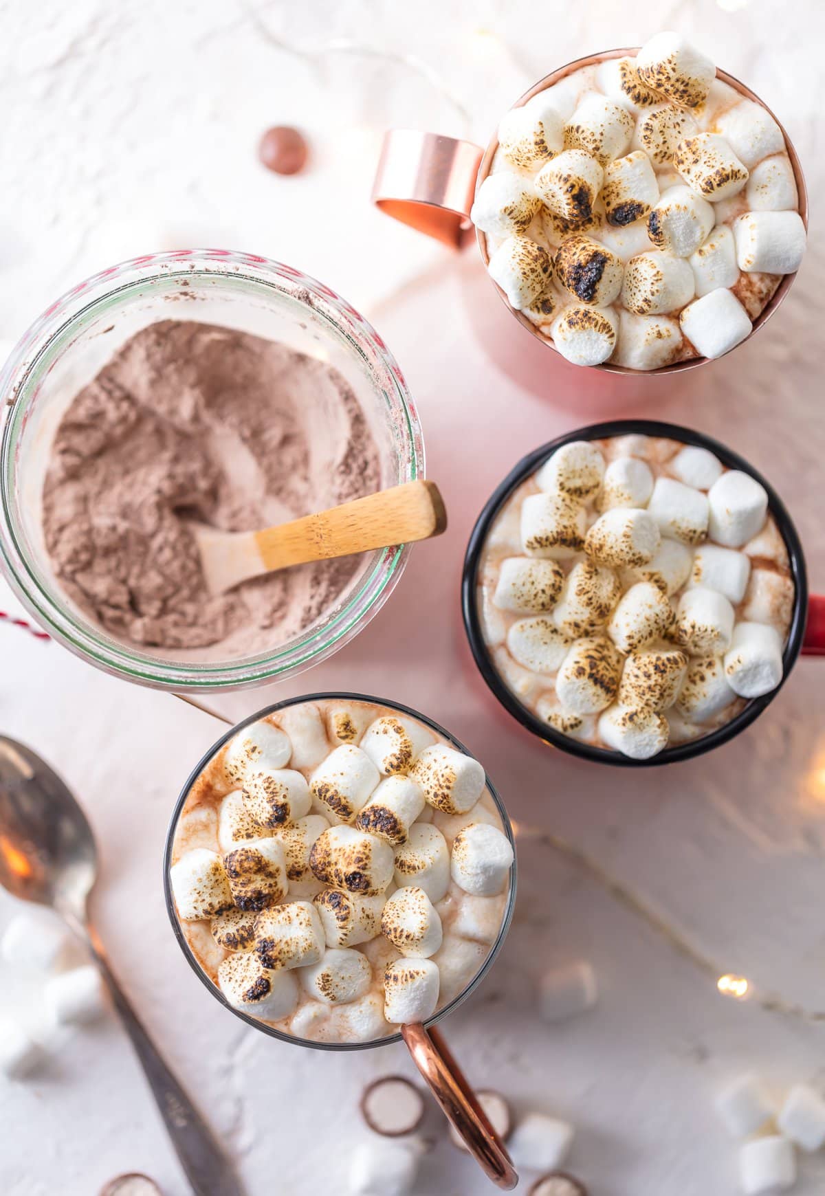 Malted Hot Chocolate topped with marshmallows in three mugs, views from above