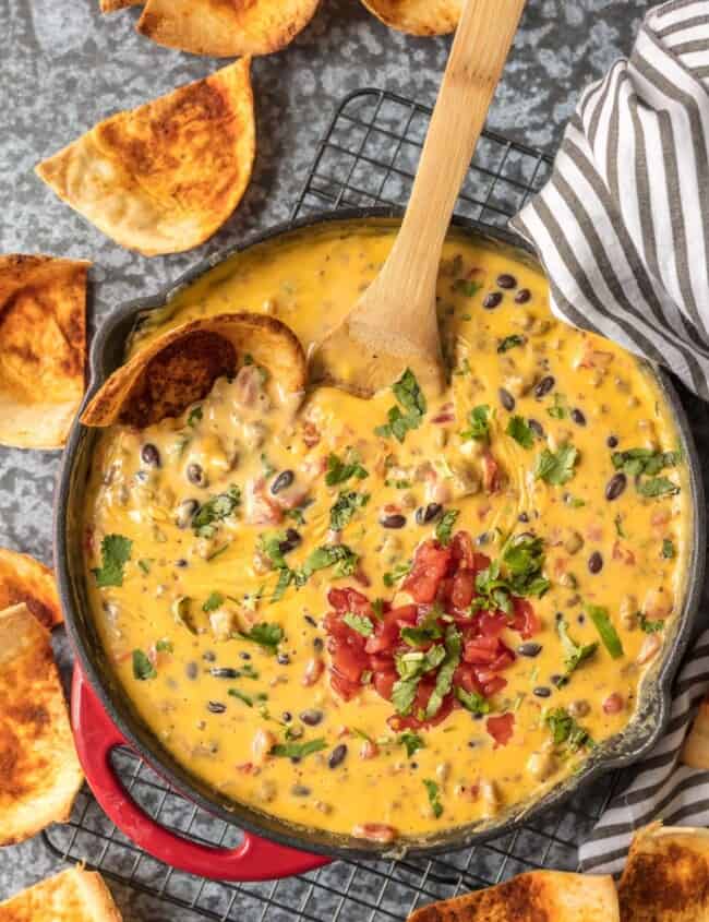 Cowboy Dip Queso (Loaded Velveeta Queso Dip) is the ultimate Super Bowl appetizer. This EASY Rotel Dip recipe is loaded with Velveeta, beer, pepper jack, black beans, Rotel, and sausage!