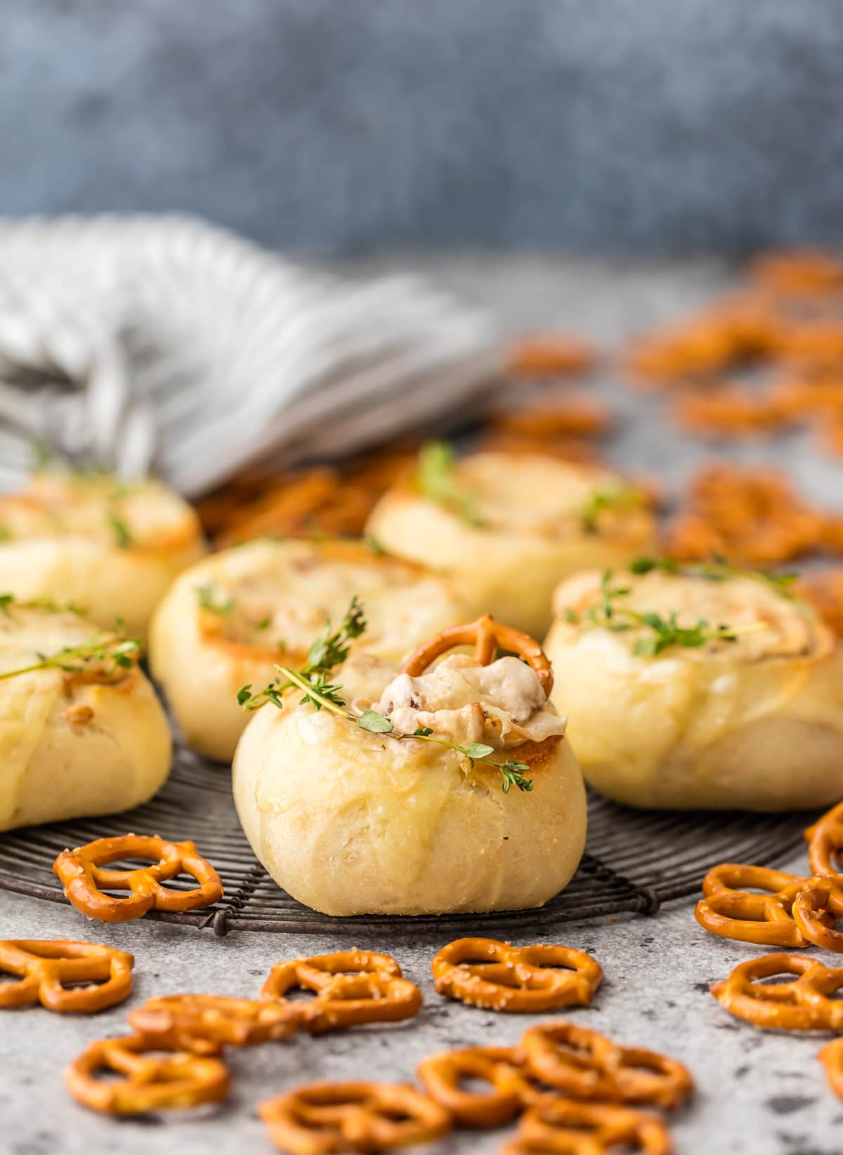 Dinner rolls turned into mini bread bowls, filled with dip and surrounded by mini pretzels