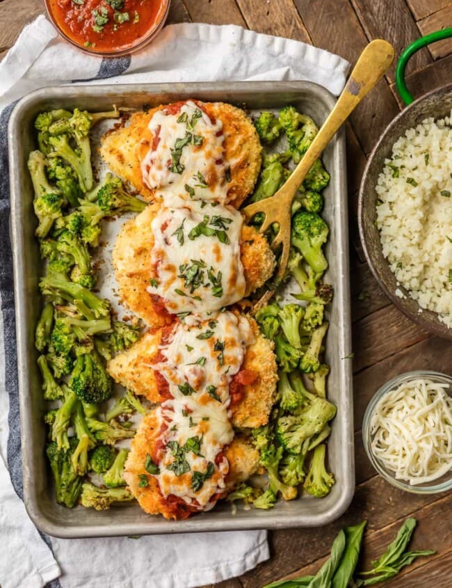 baked chicken parmesan on baking dish with broccoli