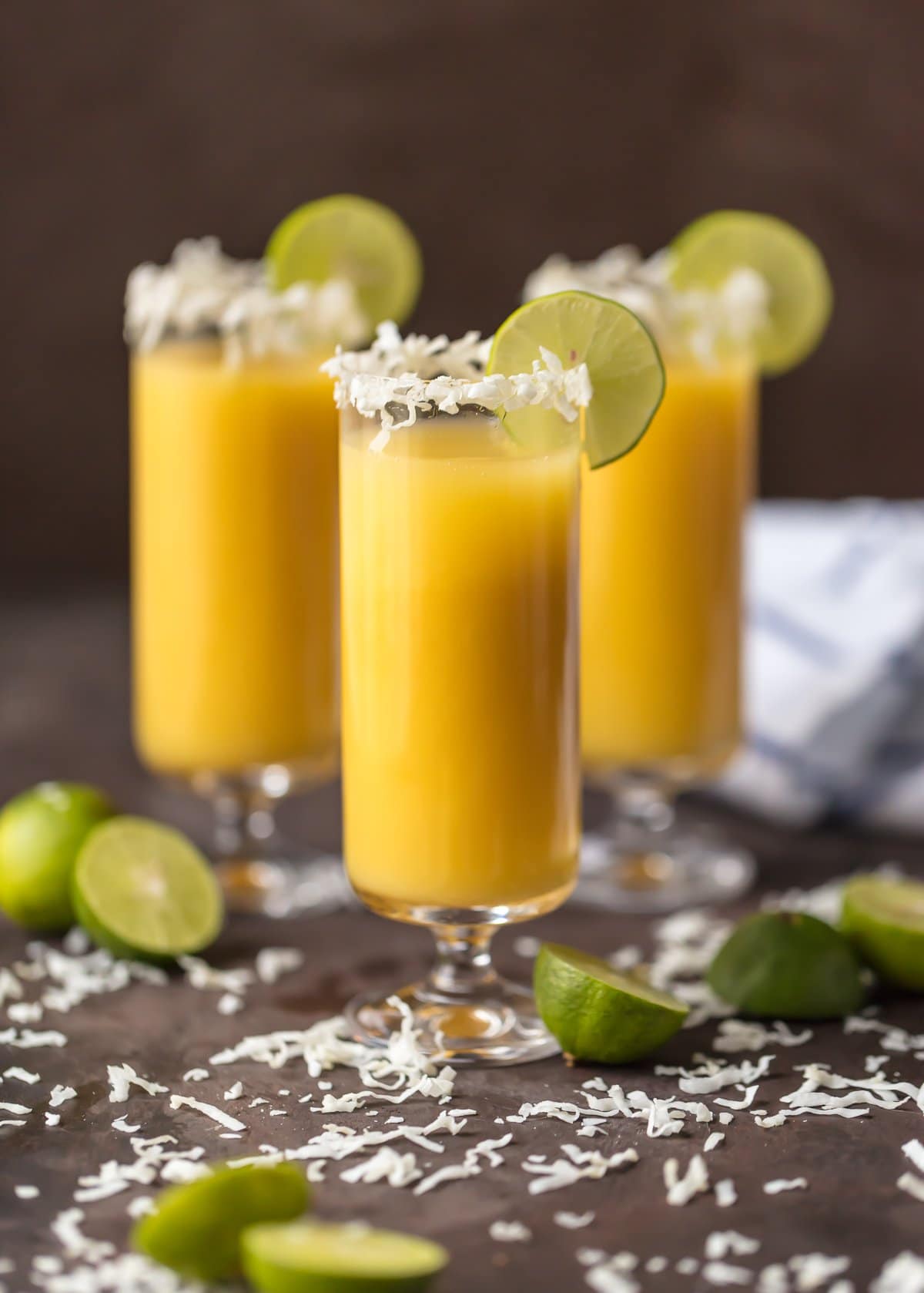 Tropical Mimosa with coconut flakes on the rim and a lime wedge