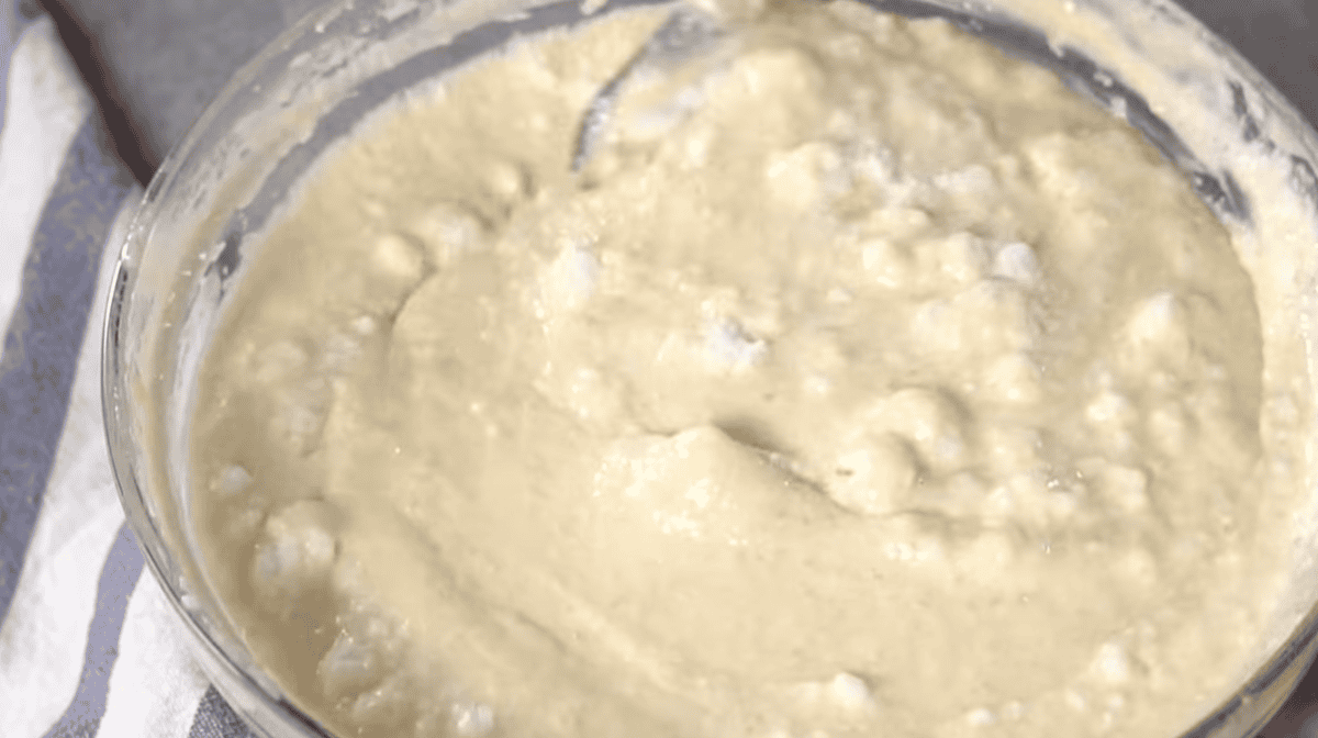 egg whites folded into pancake batter in a glass bowl.