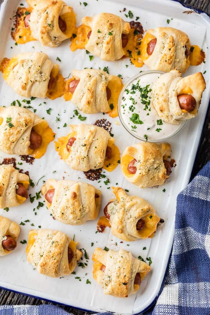 pigs in a blanket lined up on a baking tray.