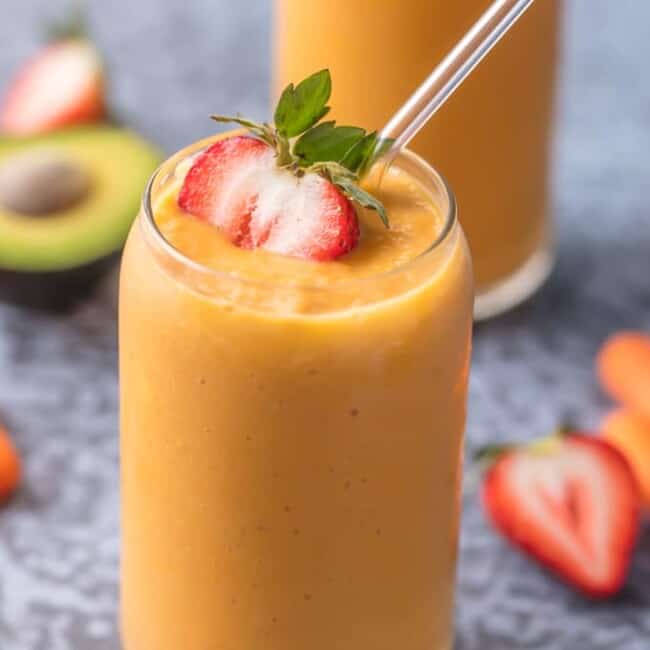 This GLOWING SKIN SMOOTHIE is full of delicious ingredients like coconut water, strawberries, mangoes, carrots, and avocado! Sip your way to beautiful skin with this easy treat.