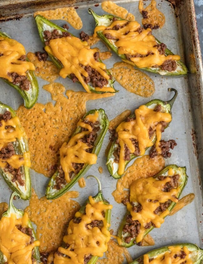 This CHEESEBURGER STUFFED JALAPENO POPPERS recipe is a fun and delicious game day appetizer! We love these spicy bites for tailgating, parties, or a tasty night spent at home.