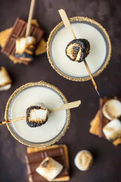 This TOASTED S'MORE MARTINI is as delicious as it is beautiful. With layers of cream, marshmallow vodka, and chocolate liqueur all you need is a graham cracker rim! So fun and festive for Fall. Cocktail photography cookbook photography